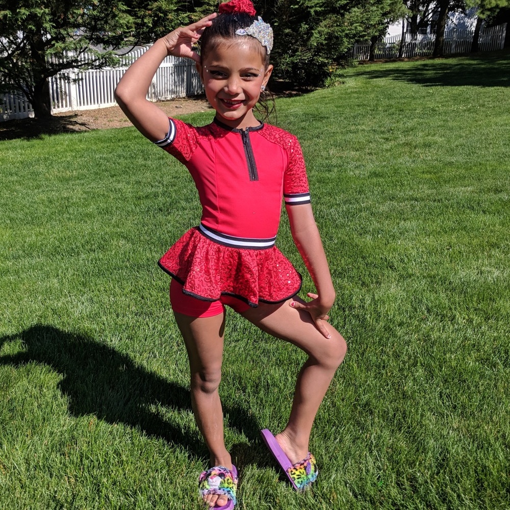 1 piece Black and red Weissman SC dance costume with Sequins. Shorts on bottom.
